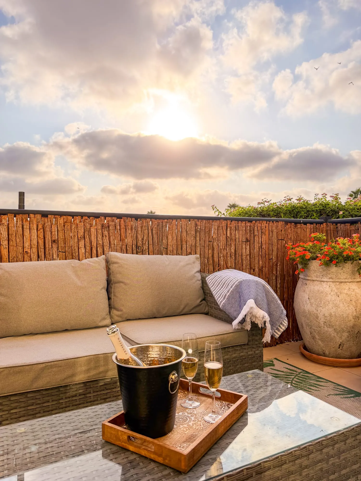 The patio sofa at sunset, with prosecco on ice on the coffee table