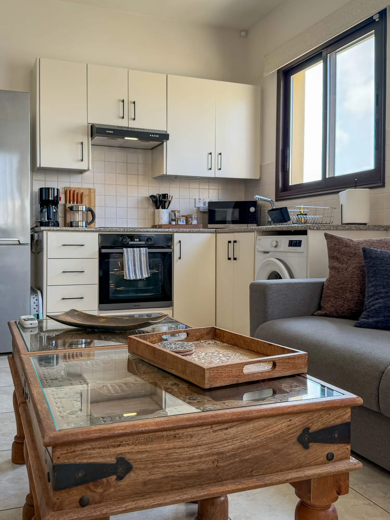 The kitchen, with the oven, hob and worktop under a bright window