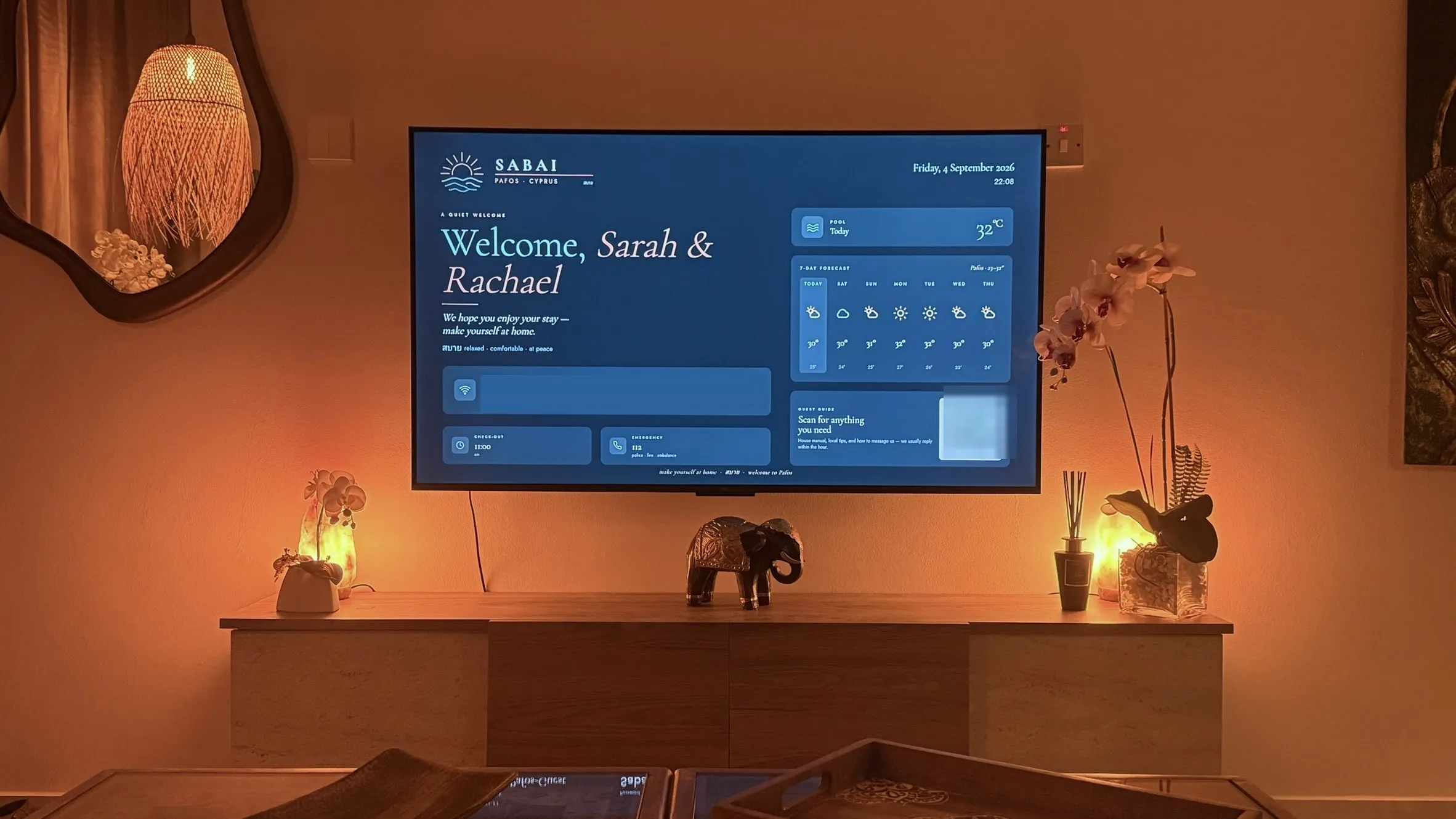 The living room TV showing the Sabai welcome screen, between two glowing salt lamps